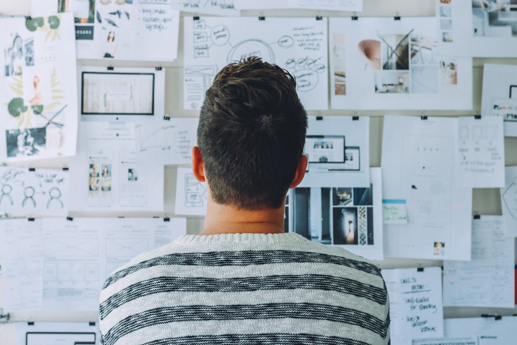 A man staring at a whiteboard wonders how software report tools can help him create value with data.